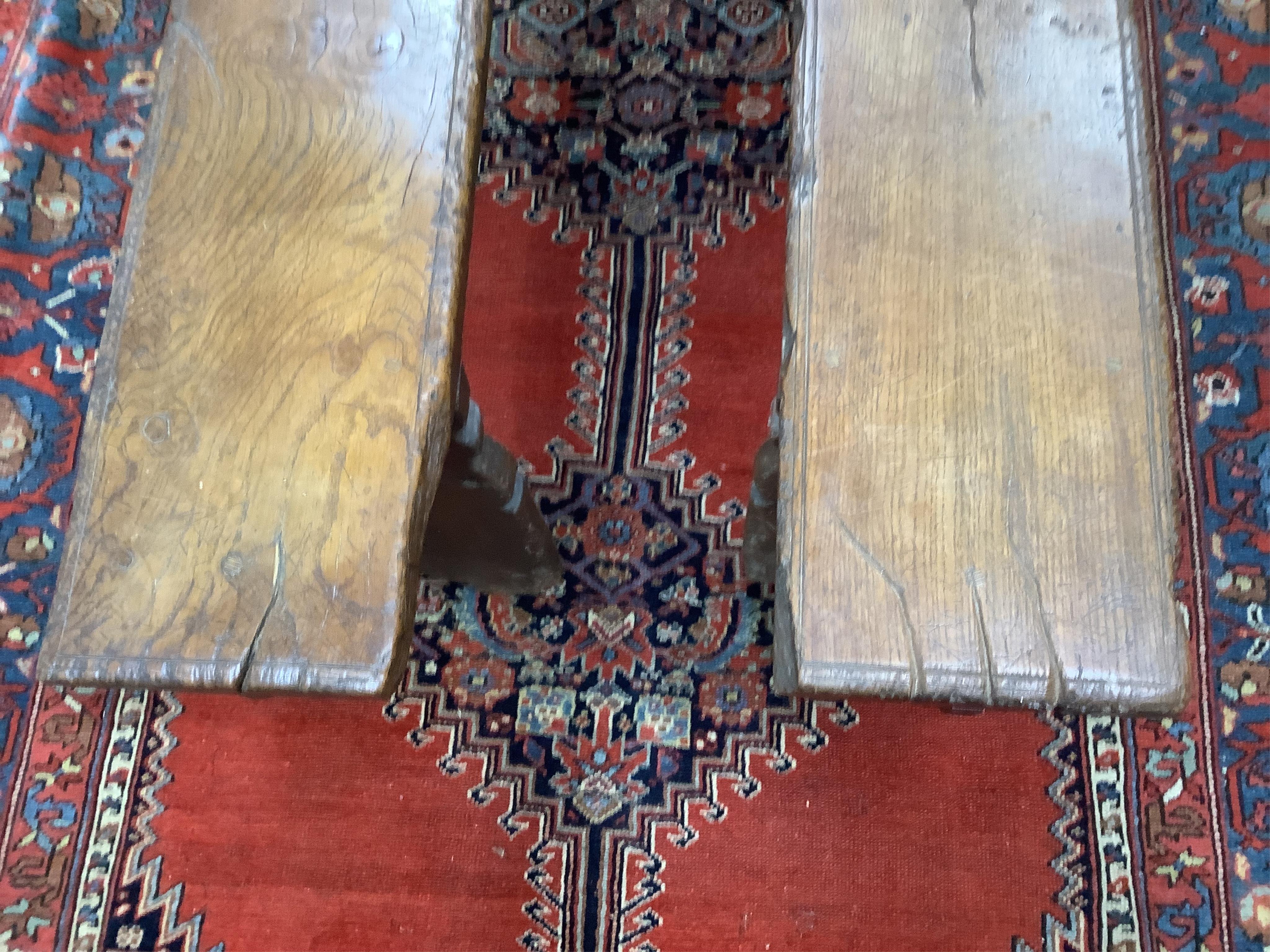 A pair of oak trestle end benches, in Elizabethan style, width 182cm, depth 25cm, height 49cm. Condition - fair, Provenance - made for Brede Place, Brede, Rye, East Sussex. Commissioned from Stuart interiors who have fur